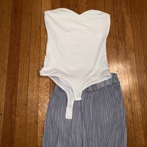 White strapless bodysuit and pleated pants.